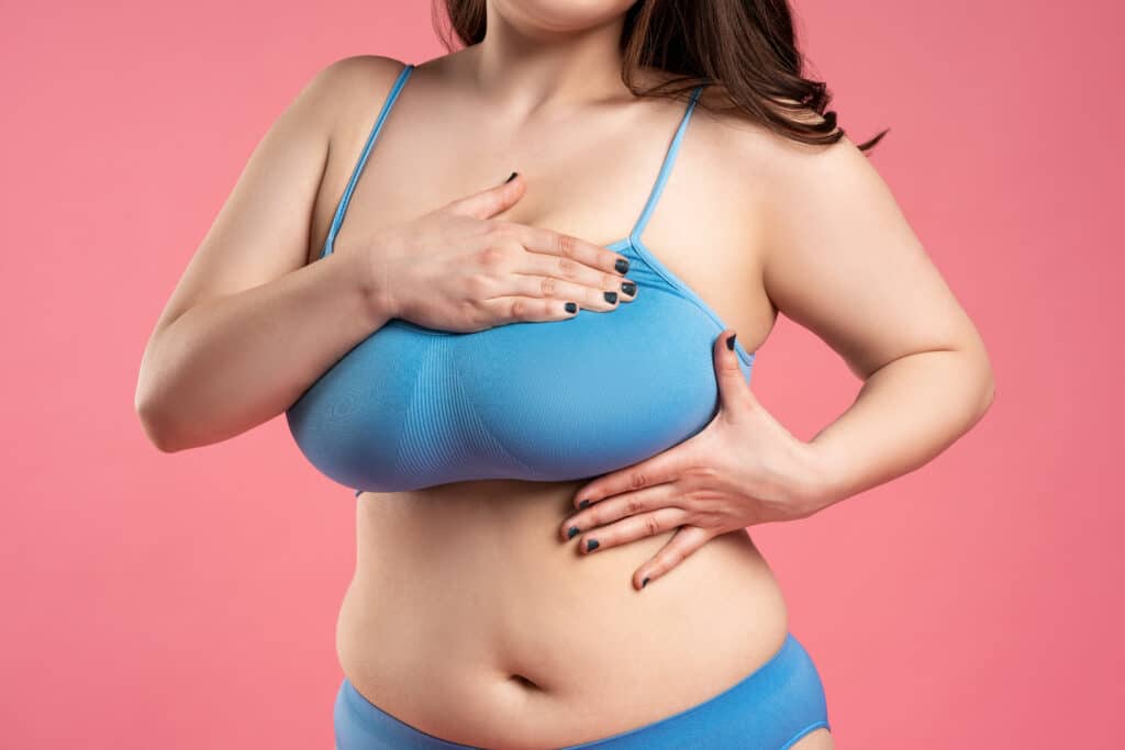 Plus sized woman in bra considering a breast lift