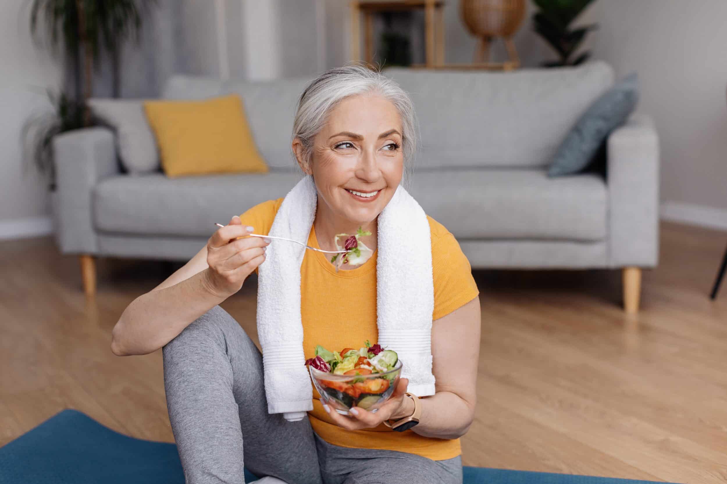 Healthy older woman eating nutritious salad