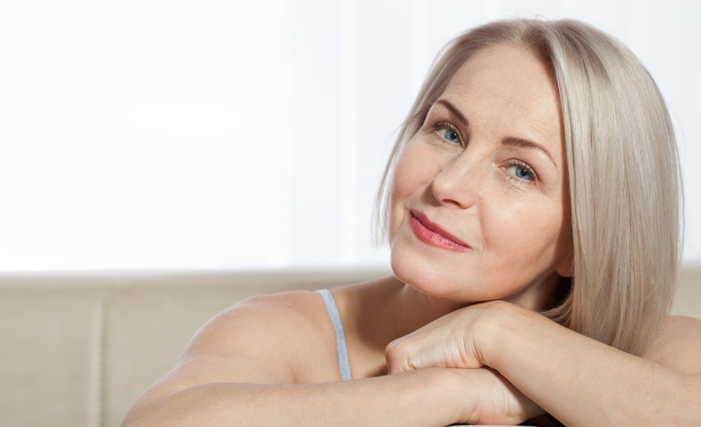 Beautiful, mature woman with smooth skin after deep plane facelift.